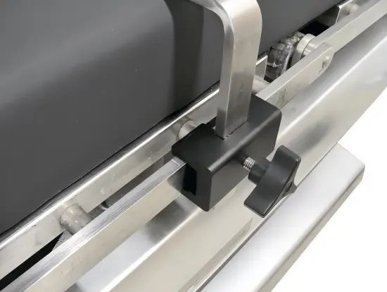 Operating room table clamp securely attached to a surgical table side rail.webp